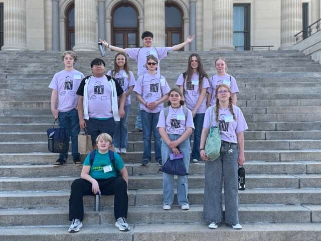 Youth Leaders in Kansas (YLinK) Advocacy Day participants gather on the State Capitol steps.