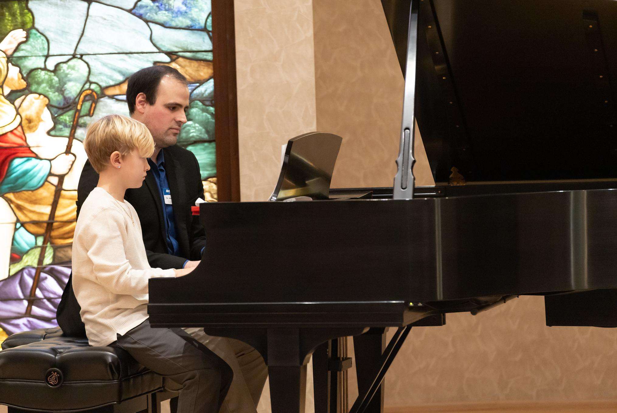 Barton Community Music School Director Dr. Alejandro Avila plays alongside a Barton Community Music School student during the fall recital.
