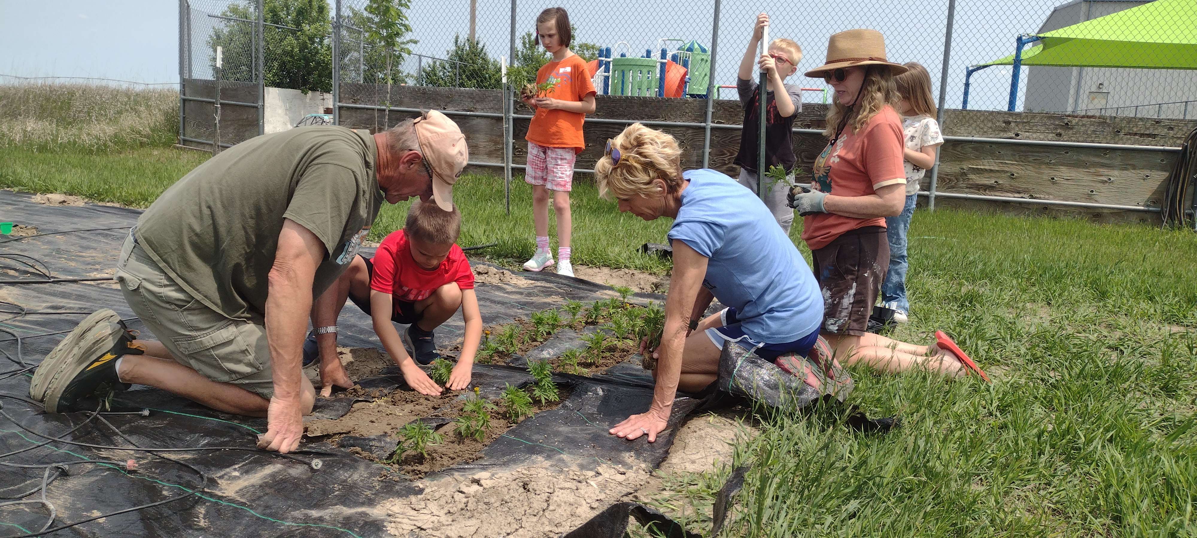 This past Frida, May 30, from left, perennial volunteers Paul and Lori Coryell and Kathy Worley from KAB help ARV summer camp students plant a garden.