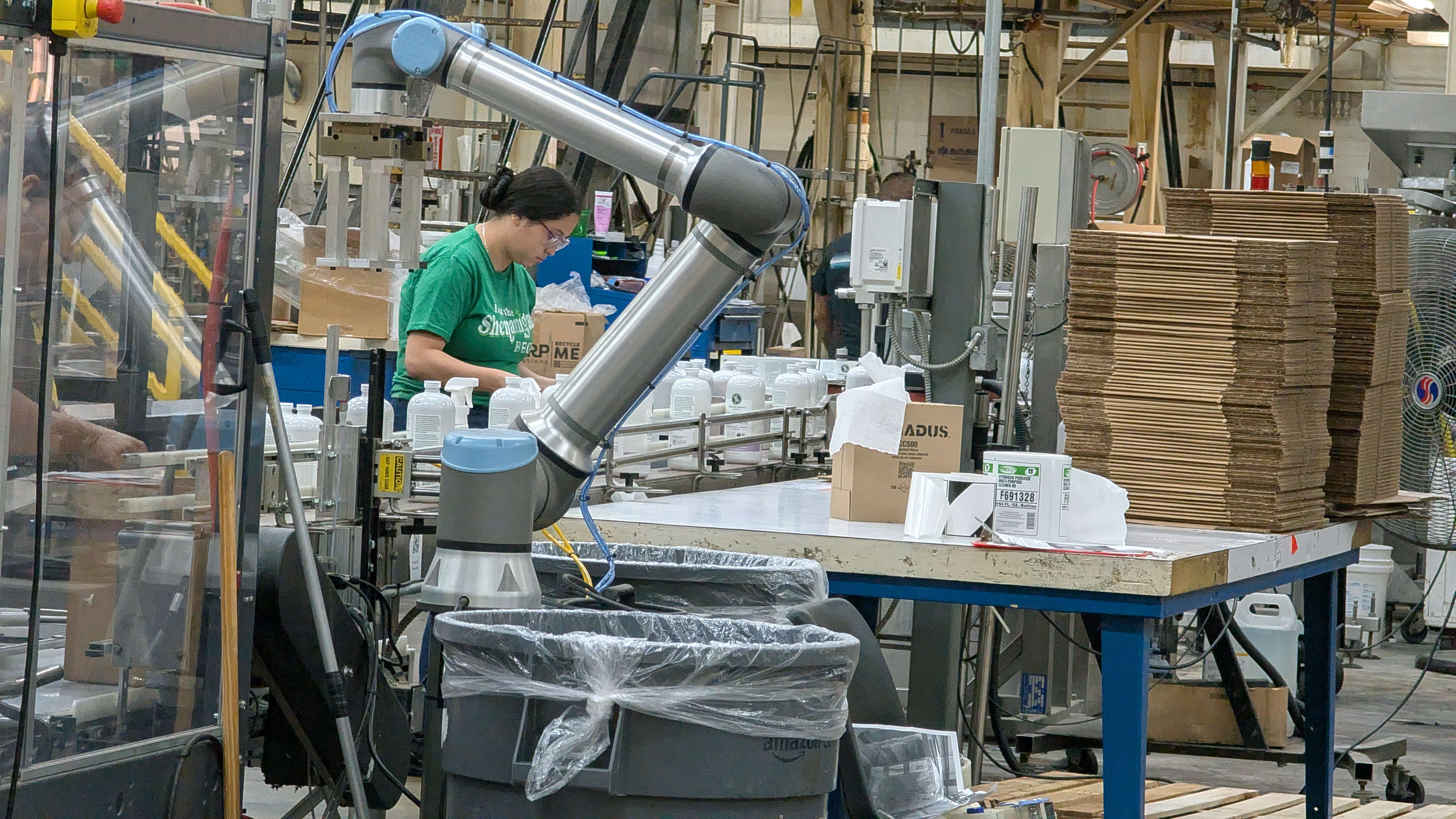 A Fuller Industries Inc. employee monitors as newly filled bottles of all-purpose cleaner are packed into boxes. Fuller uses over 25,000 gallons of water daily to make its many products and continually tests to make sure wastewater is safe to discharge.