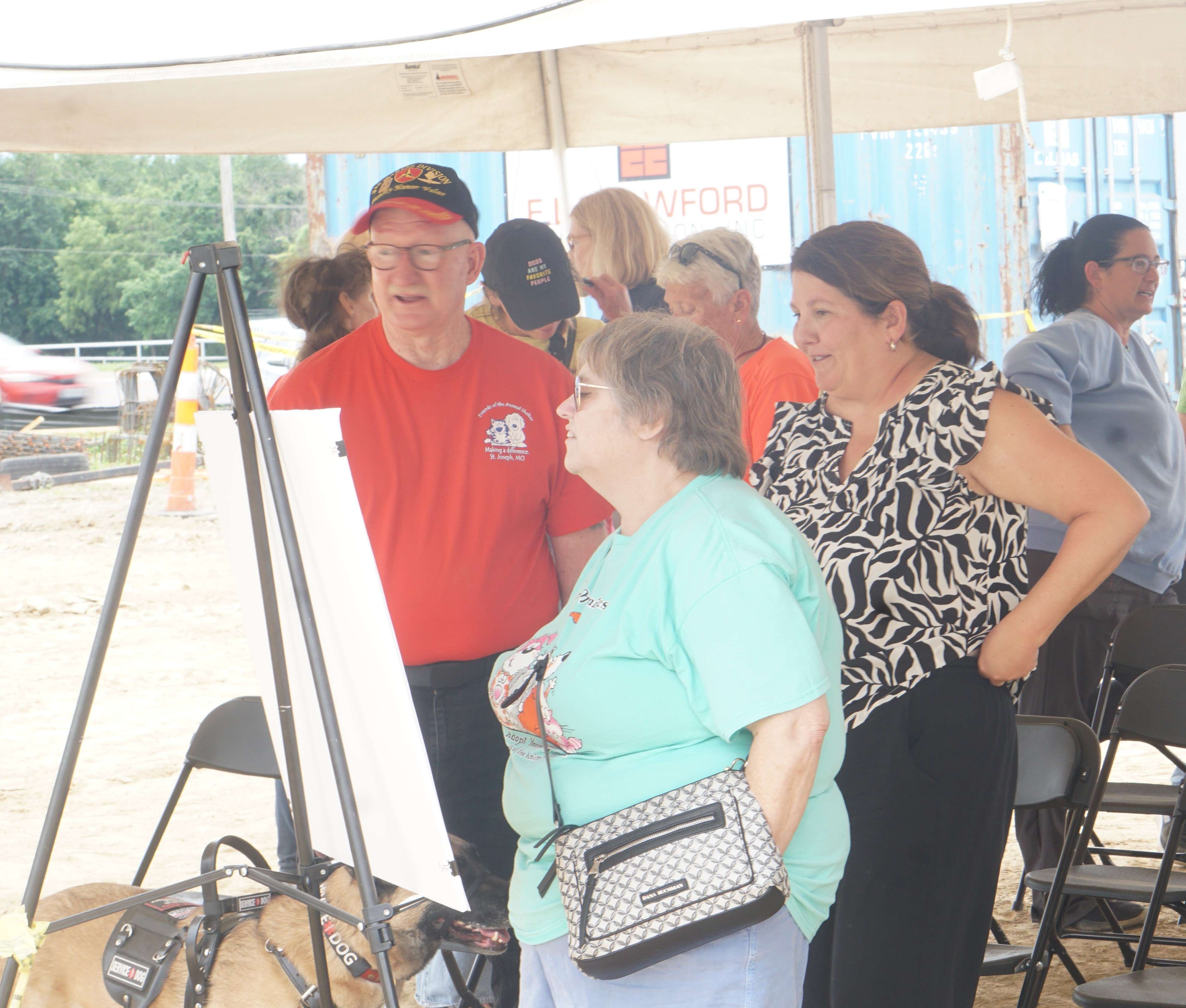 Friends of the Animal Shelters Ed Vanover (left) and other St. Joseph residents look at an artist rendering of the new animal shelter during the groundbreaking event/Photo by Matt Pike