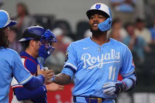 Kansas City Royals' Maikel Garcia celebrates his home run that scored teammates Jonathan India and Bobby Witt Jr. during the fourth inning of a baseball game against the Texas Rangers, Wednesday, June 18, 2025, in Arlington, Texas. (AP Photo/LM Otero)