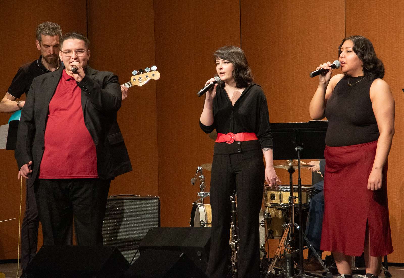 Chadron State College Vocal Jazz members Shawn Bailey of Bellevue, Iowa, left, Olivia Valadez of Alliance, Neb., middle, and Rayne Charging Thunder of Gordon, Neb., right, perform on April 15, 2025, in the Memorial Hall Auditorium. (Photo by Tena L. Cook/Chadron State College)