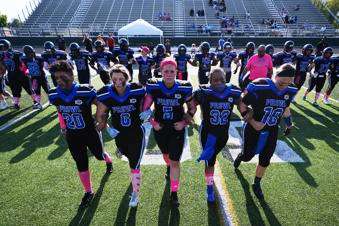  Detroit Prowl's Toya Shinaul, from left to right, Kelly Bernadyn, Sydney Hebel, Jasmine Hamilton and Allie Gorcyca walk out for the coin toss at the start of an AWFL women's football game against the Lansing Legacy, in Allen Park, Mich., Saturday, May 10, 2025. (AP Photo/Paul Sancya)