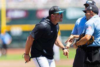  Coastal Carolina head coach Kevin Schnall, left, screams at the umpires after being ejected in the first inning against LSU in Game 2 of the NCAA College World Series baseball finals in Omaha, Neb., Sunday, June 22, 2025. (AP Photo/Rebecca S. Gratz)