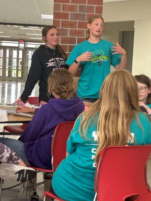 Brooklyn Cooley, left, Great Bend High School, and Jaci Sandberg, Ellinwood High School, present information about a Barton County Youth Crew idea for a community-service project. They made their presentation at a recent Youth Leaders in Kansas meeting.