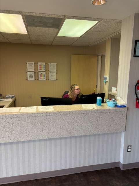Betty Eisenhour, certified nurse’s aide, tends the front desk at the new Heart of Kansas Family Health Care clinic in St. John.