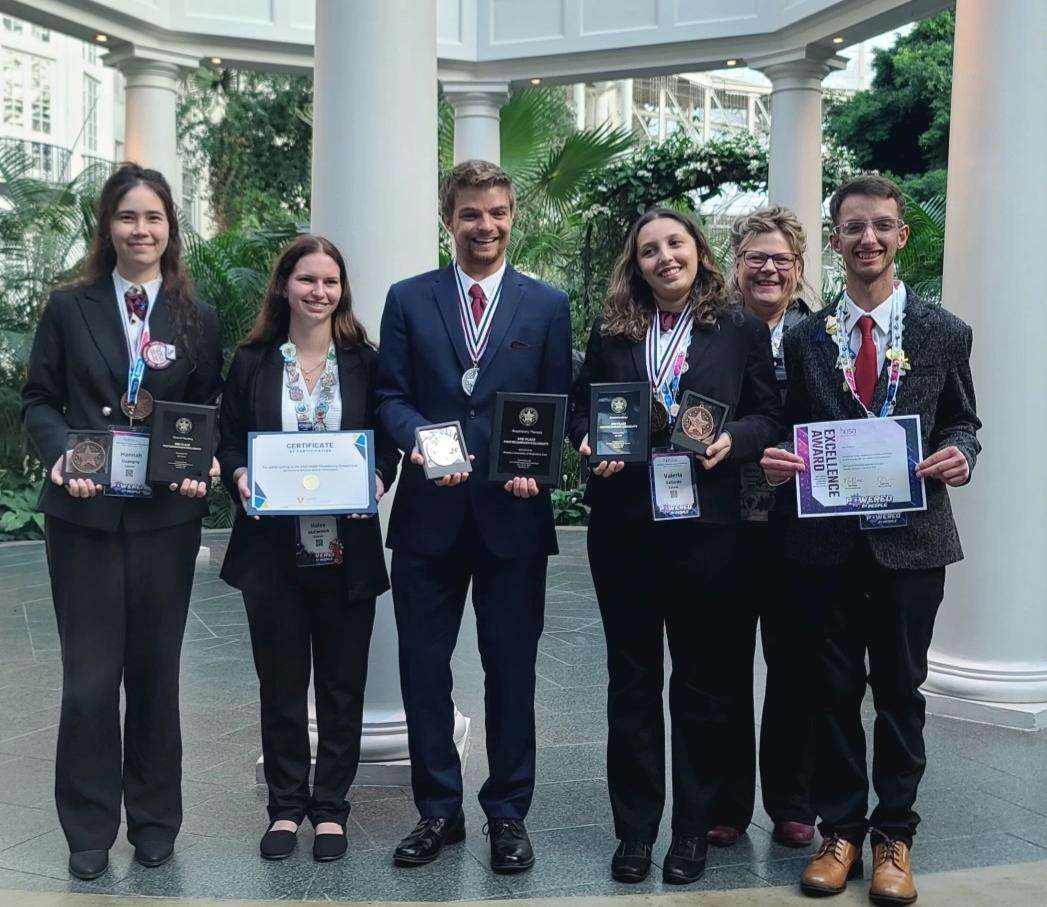 (From left) Hannah Dapogny, Haley McCormick, Kaden Baird, Valeria Gallardo, Karen Gunther (Barton Advisor), and Aaron Deason pose for a photo at the HOSA International Leadership Conference in Nashville, Tennessee from June 18-23.
