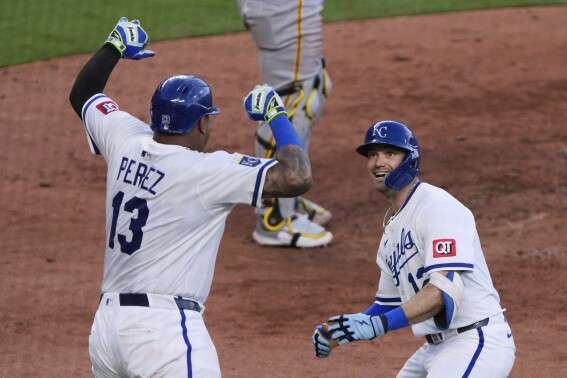 Kansas City Royals' Nick Loftin (12) celebrates with Salvador Perez (13) after hitting a two-run home run during the seventh inning of a baseball game against the Pittsburgh Pirates Tuesday, July 8, 2025, in Kansas City, Mo. (AP Photo/Charlie Riedel)