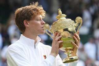 Jannik Sinner of Italy holds the trophy after winning the men's singles final match against Carlos Alcaraz of Spain at the Wimbledon Tennis Championships in London, Sunday, July 13, 2025.(AP Photo/Kirsty Wigglesworth)