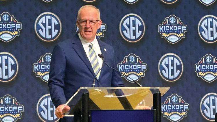 SEC Commissioner Greg Sankey discusses the annual conference highlights with Chief Public Relations Officer for the University of Arkansas Kevin Trainor, sitting right, at the College Football Hall of Fame in Atlanta, Monday, July 14, 2025. (Hunter Dawkins/The Gazebo Gazette via AP)