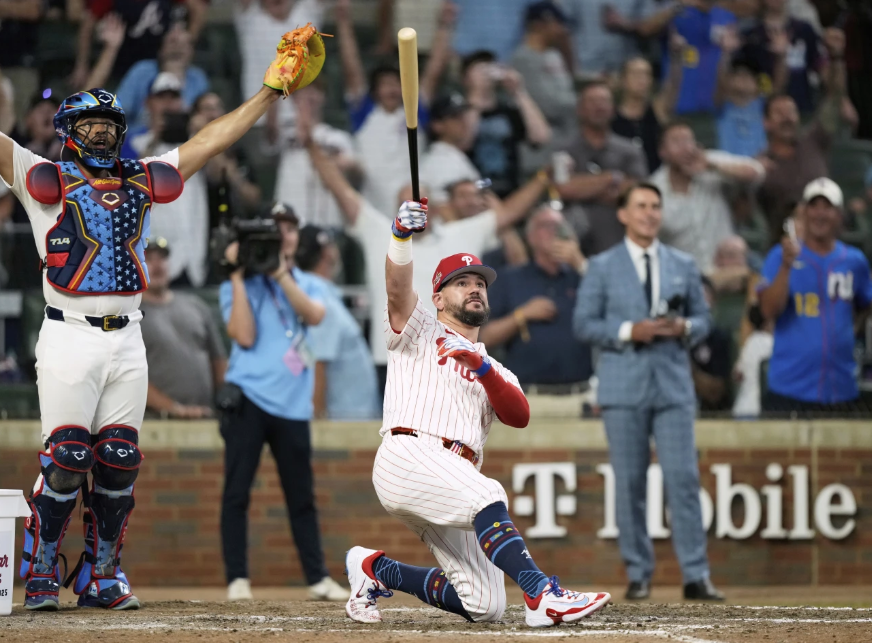 Philadelphia Phillies Kyle Schwarber celebrates after winning the tiebreaker at the MLB baseball All-Star game between the American League and National League, Tuesday, July 15, 2025, in Atlanta. (AP Photo/Brynn Anderson)