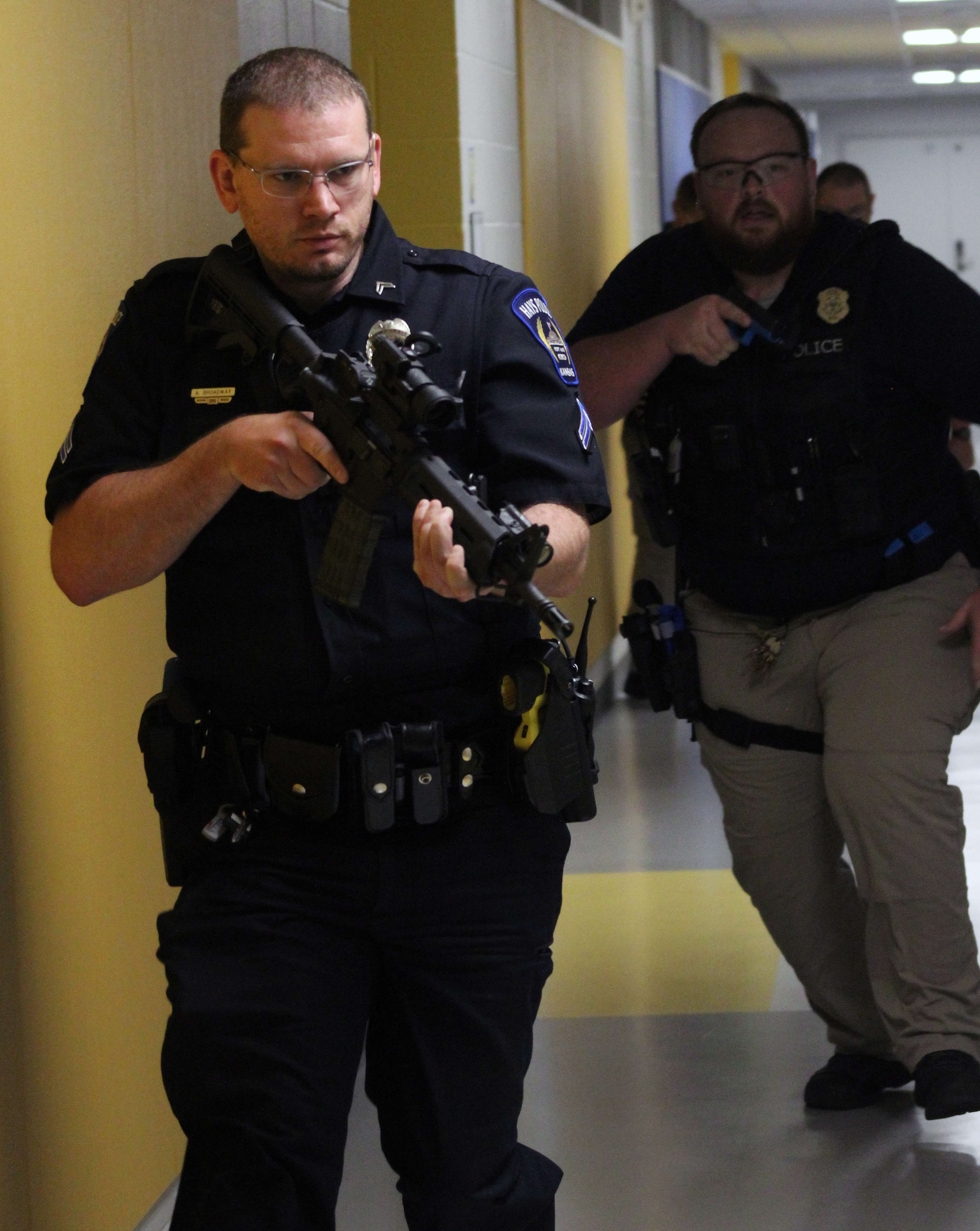 Officers respond to shots being fired during an active shooter training Wednesday at Roosevelt Elementary School. Officers used blank rounds to engage actors in multiple scenarios.&nbsp;Photo by Cristina Janney/Hays Post