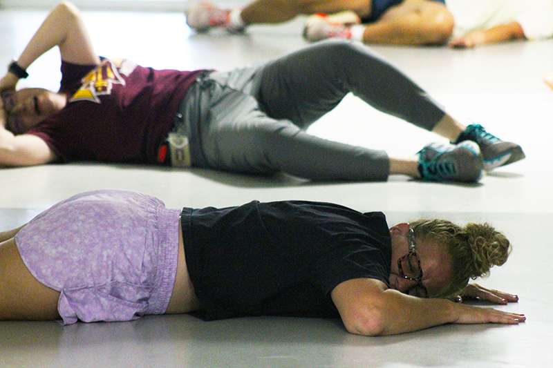 School staff play the role of victims in an active shooter training on Wednesday at Roosevelt Elementary School. The actors were asked to cry out to simulate the chaos that officers would face during a real active shooter incident. Photo by Cristina Janney/Hays Post