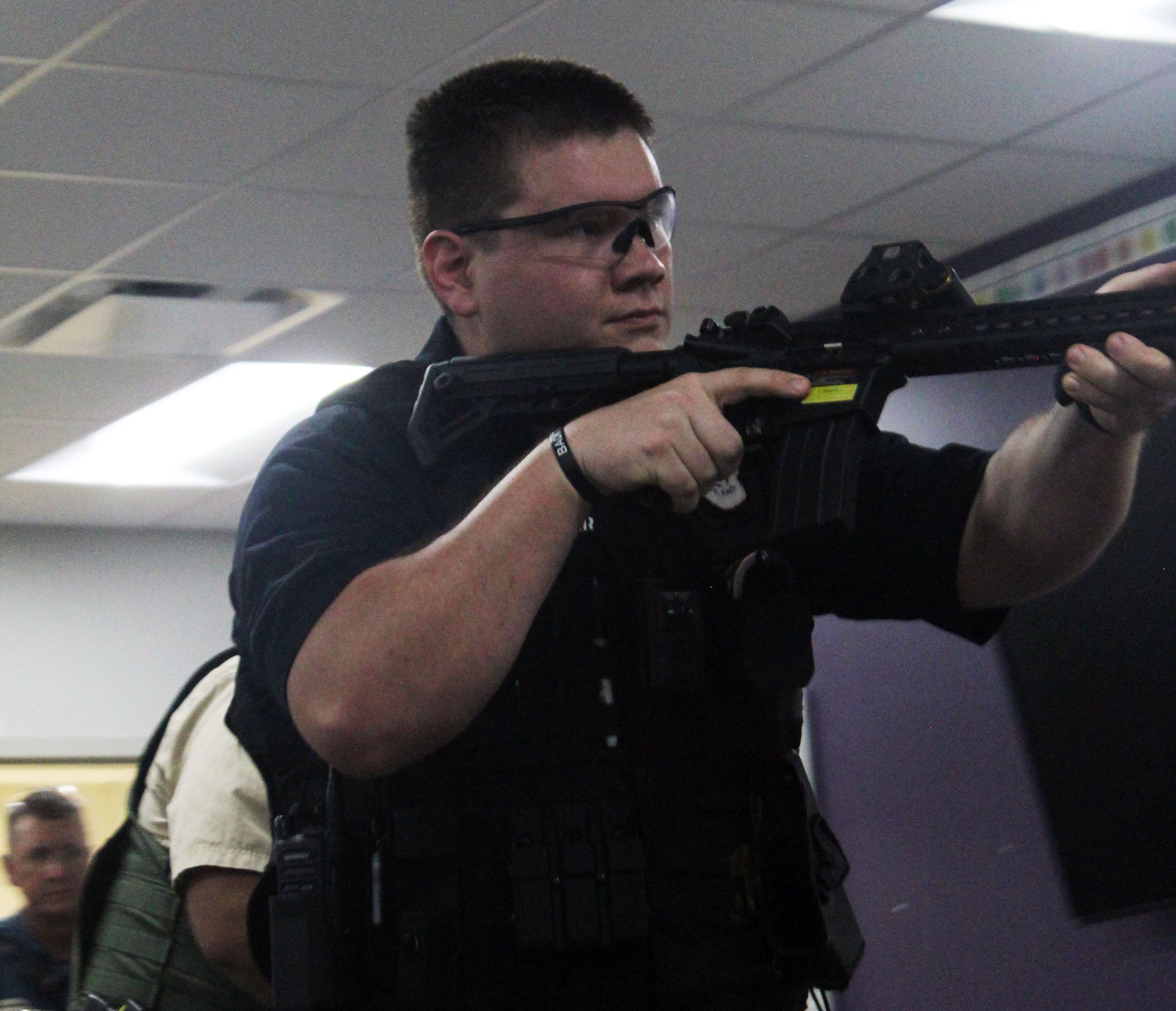 An officer helps check a room for additional threats during active shooter training on Wednesday. Photo by Cristina Janney/Hays Post