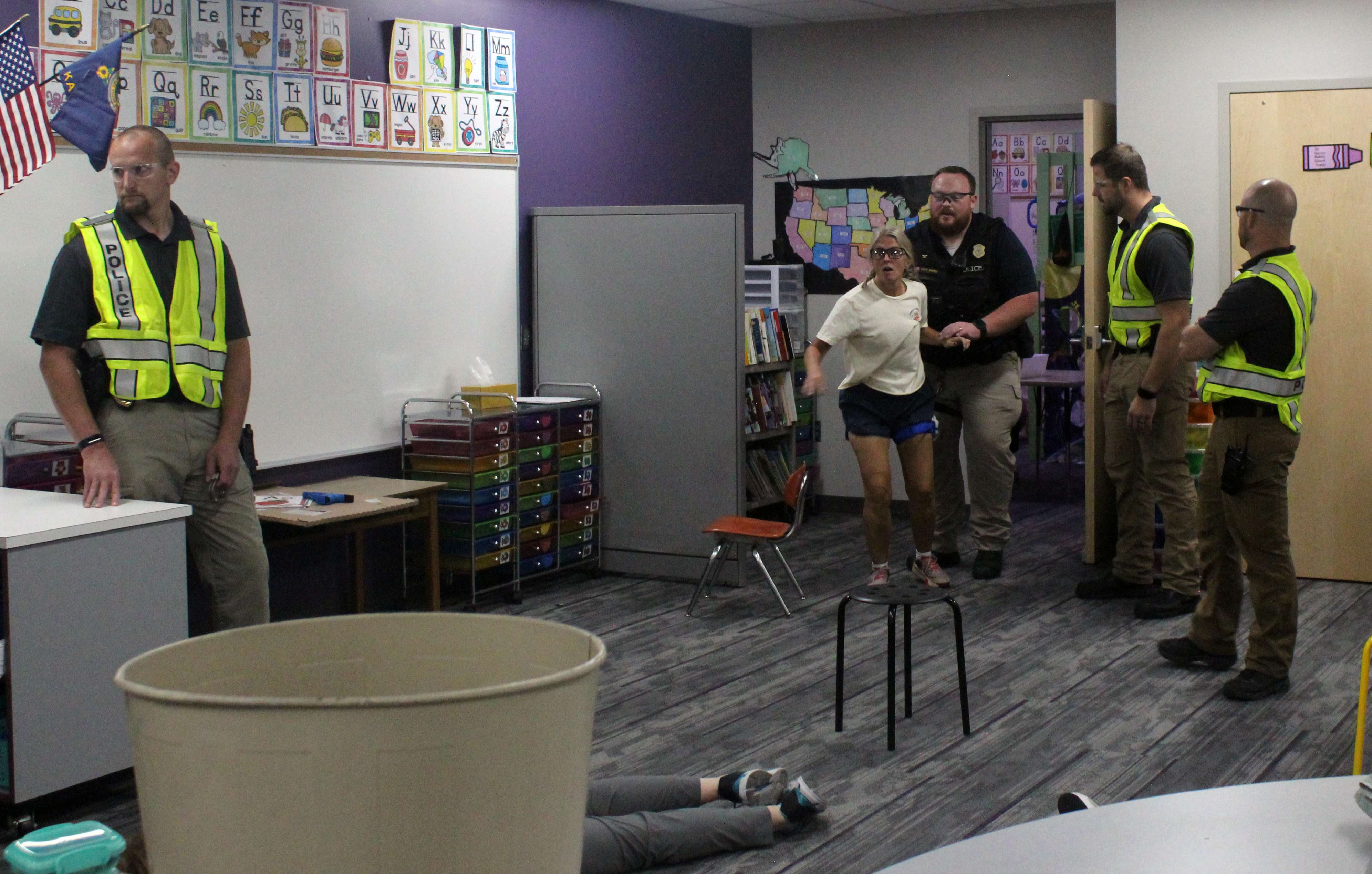An officer evacuates an injured victim as training officers observe during active shooter training Wednesday. Photo by Cristina Janney/Hays Post