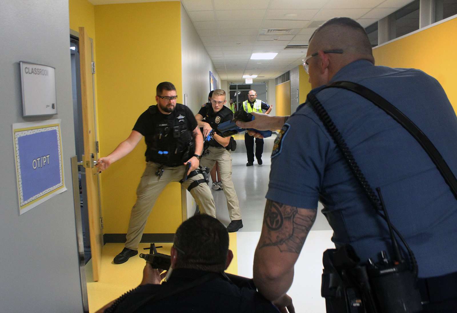 Officers prepare to breach a classroom with a suspected active shooter inside during training Wednesday at Roosevelt Elementary School. Photo by Cristina Janney/Hays Post