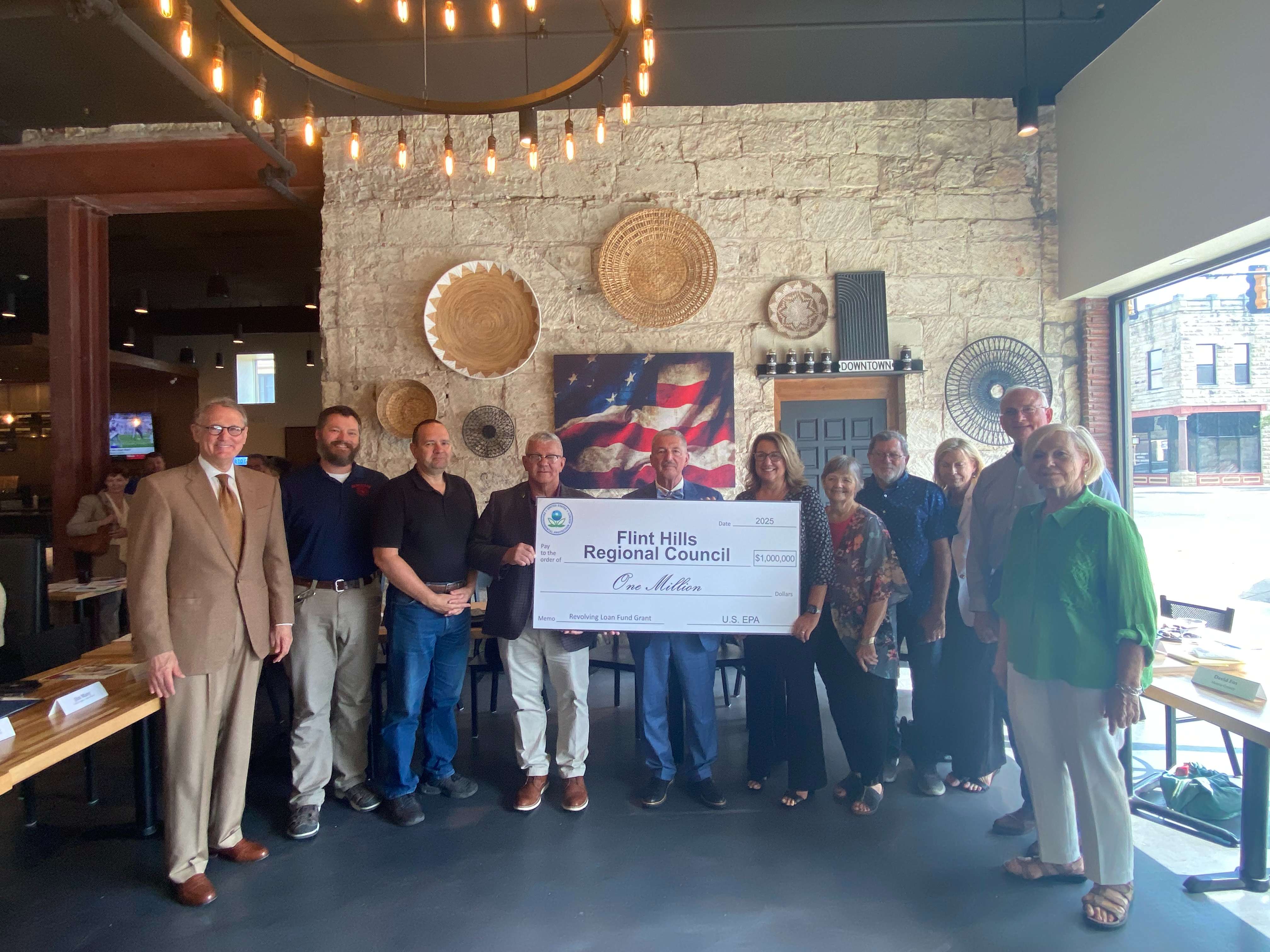 The board members for the Flint Hills Regional Council all took a photo with the $1 million check.