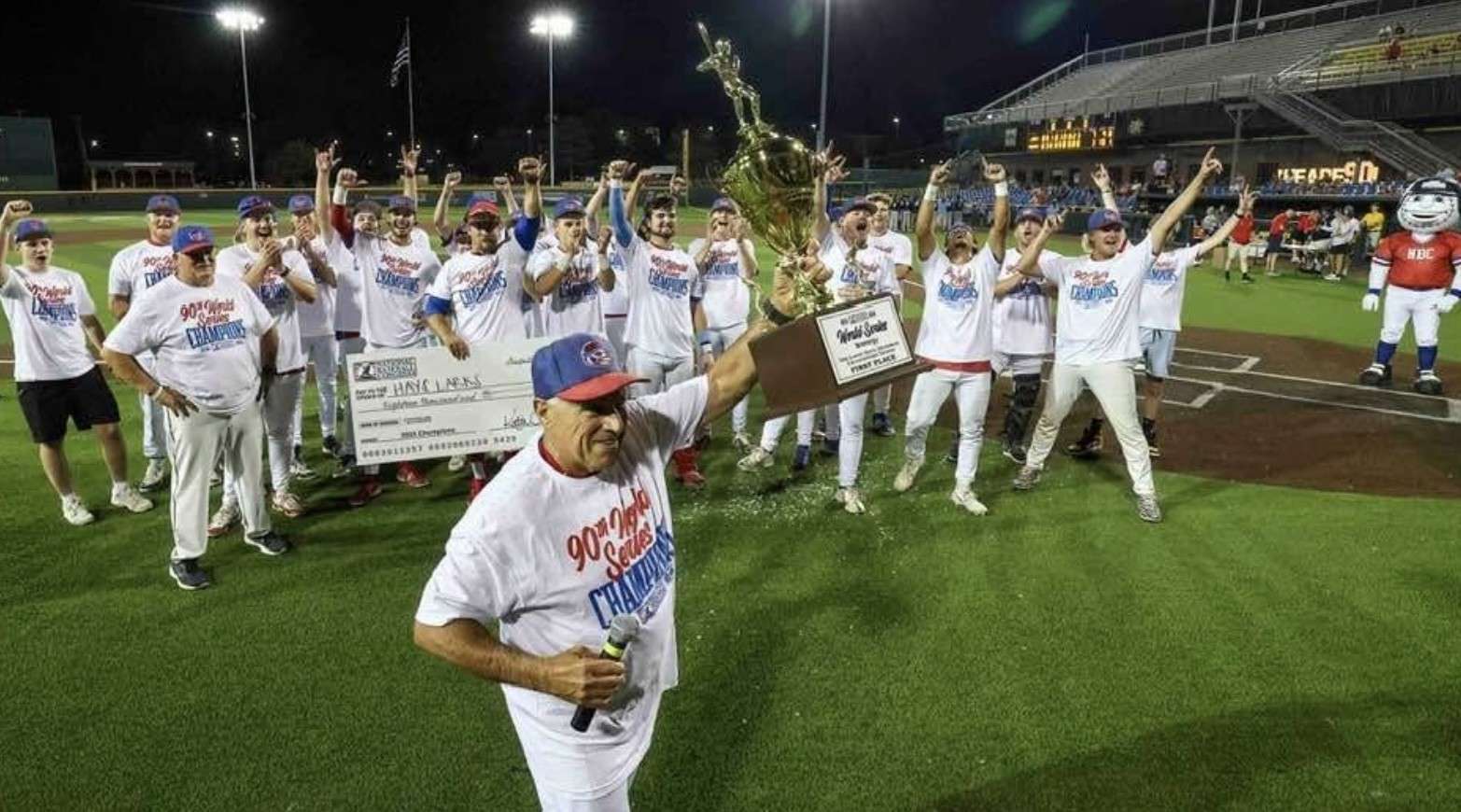 Hays Larks manager Frank Leo holds aloft the NBC World Series championship trophy after the team’s first national title last summer. Courtesy photo