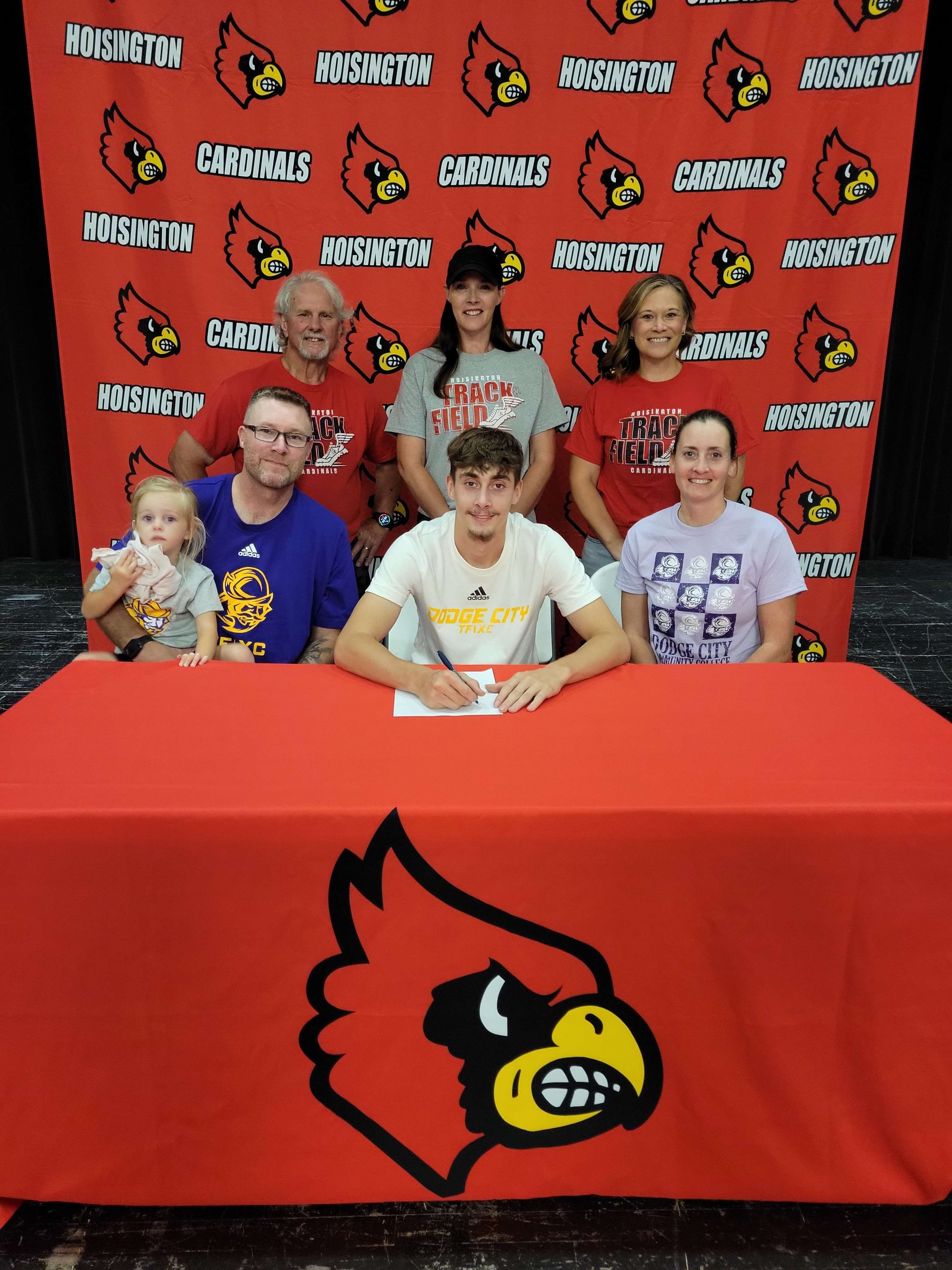 Hoisington's Brier Thompson recently signed a letter of intent to run at Dodge City Community College next year. Pictured, front row from left: Dad (Brook Thompson) holding little sister, Brier, and Mom (Coach Lisa Thompson). Back row: HHS head coach Daniel Schmidt, hurdle coach Stacey Dame, and relay coach Mandy Mason.