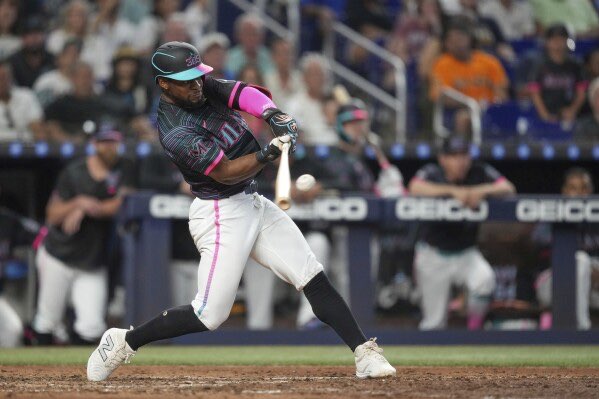 Miami Marlins' Otto Lopez hits a double to bring in two runs in the eighth inning of a baseball game against the Kansas City Royals, Saturday, July 19, 2025, in Miami. (AP Photo/Rebecca Blackwell)
