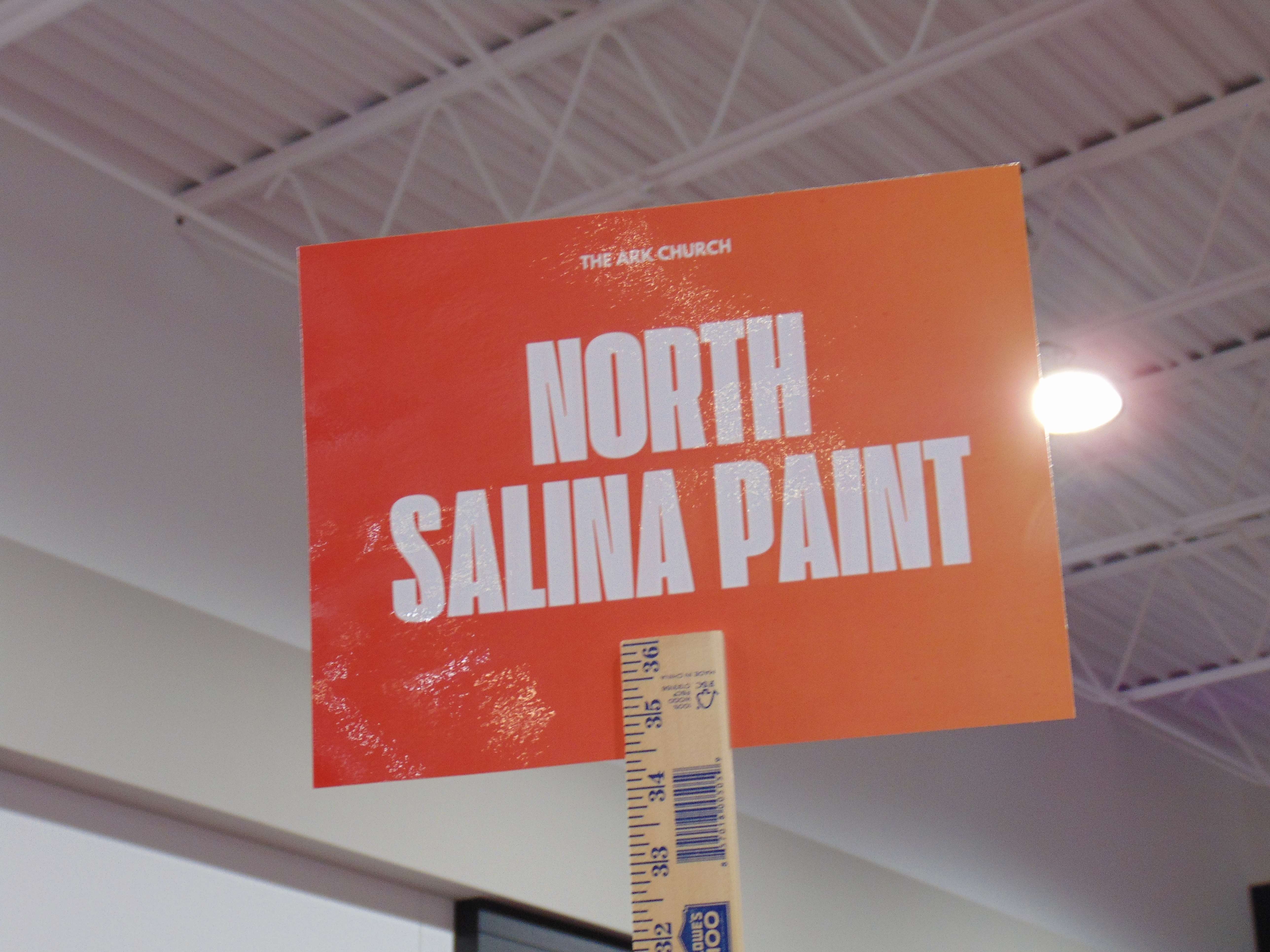 North Salina Paint sign held up during "Serve Day" on Saturday, July 19; photo by Nicolas Fierro