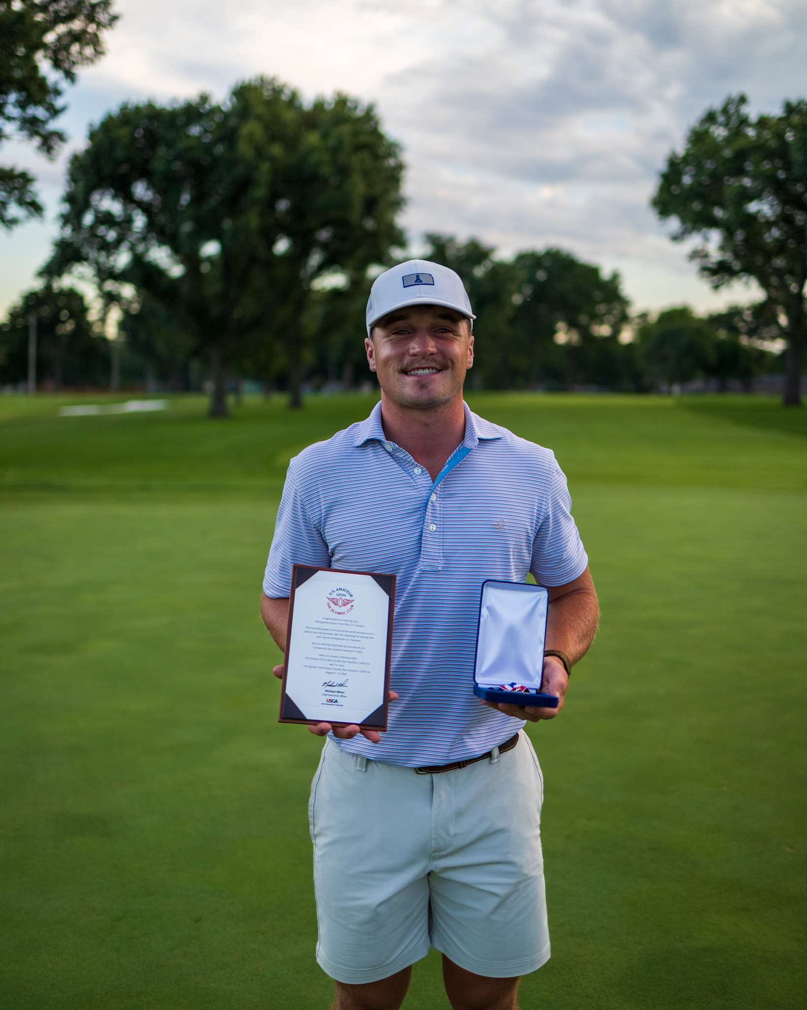 Ty Adkins holds his medal and qualifying certificate after shooting a 6-under-par 66 at Milburn Country Club in Overland Park, Kan., on Monday, July 21, 2025, to earn a spot in the 125th U.S. Amateur Championship at The Olympic Club in San Francisco.