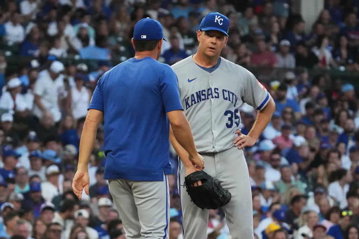 Kansas City Royals starting pitcher Rich Hill, right, talks with pitching coach Brian Sweeney during the second inning of a baseball game against the Chicago Cubs in Chicago, Tuesday, July 22, 2025. (AP Photo/Nam Y. Huh)