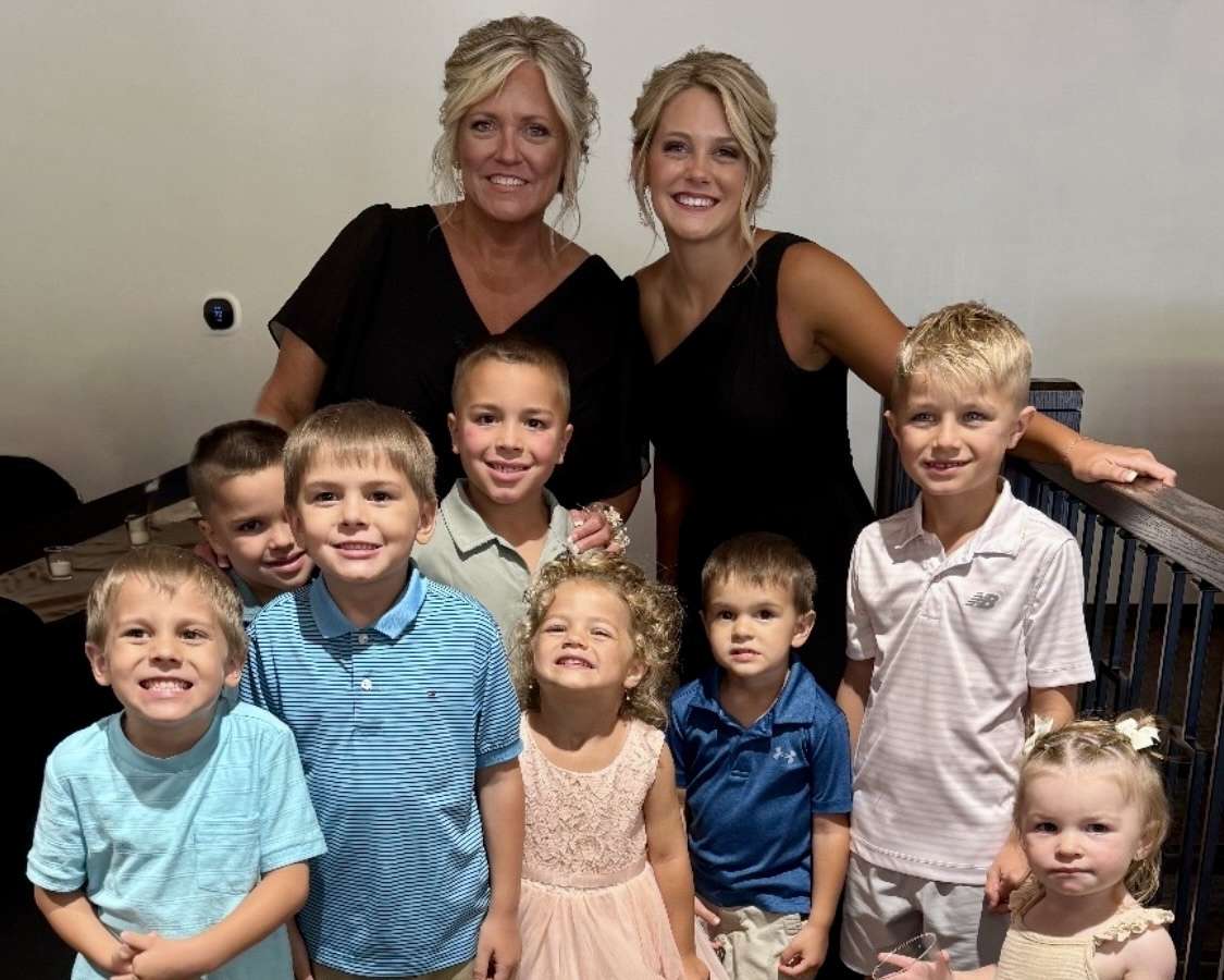 Jennifer Goetz (left), July's Child Care Champion, with her daycare children at her oldest daughter's wedding in June. Courtesy photo