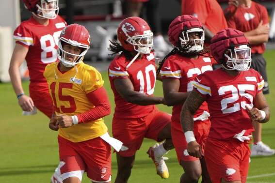 Kansas City Chiefs quarterback Patrick Mahomes (15) runs with teammates at NFL football training camp Tuesday, July 22, 2025, in St. Joseph, Mo. (AP Photo/Charlie Riedel)