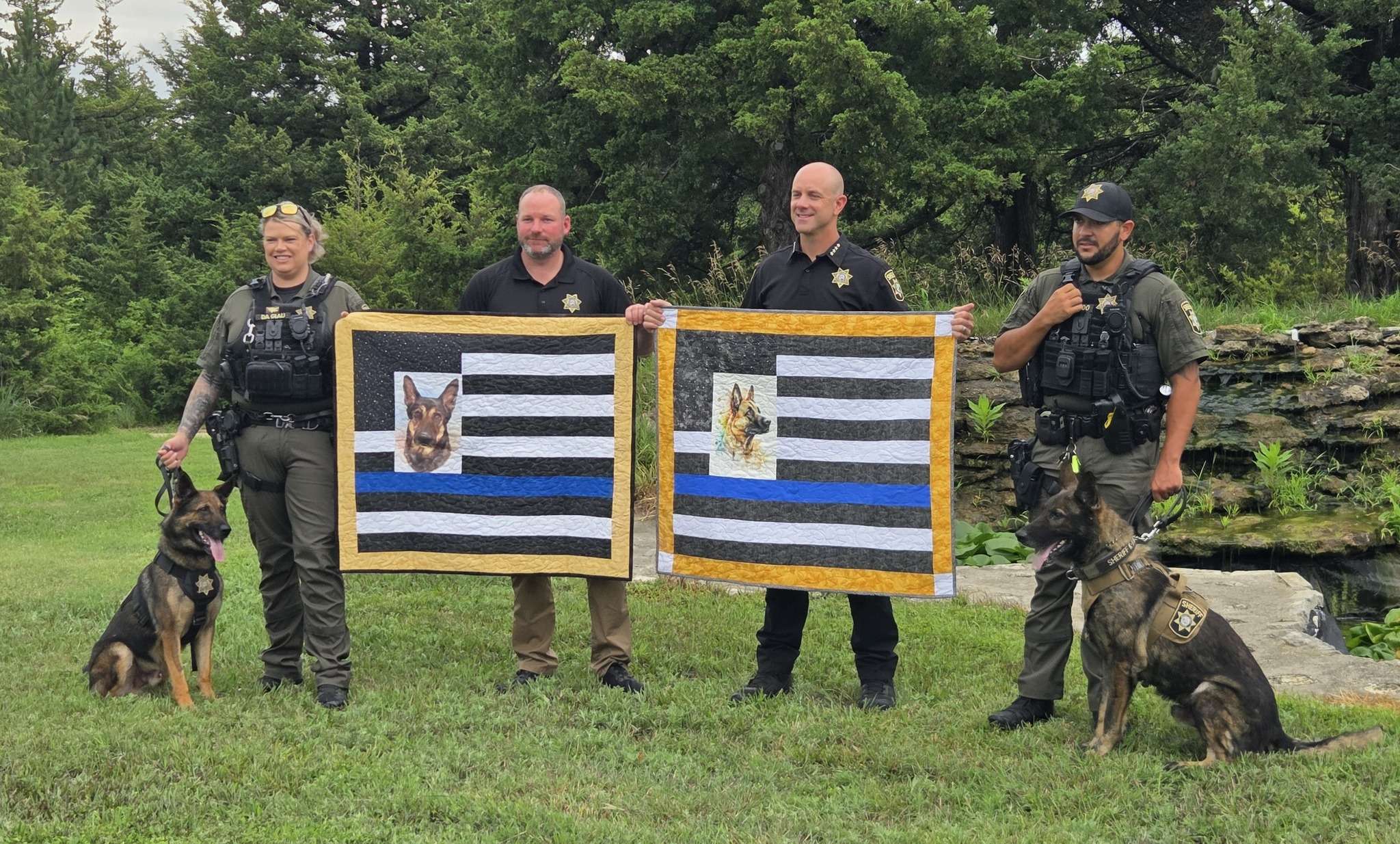 Enzo with Handler Deputy Cayla Da Giau; Undersheriff Justin Stopper; Sheriff Nate Boeckman and Handler Deputy James Regalado with his K-9, Klesto. (Photo - Geary County Sheriff's Office Facebook Page)