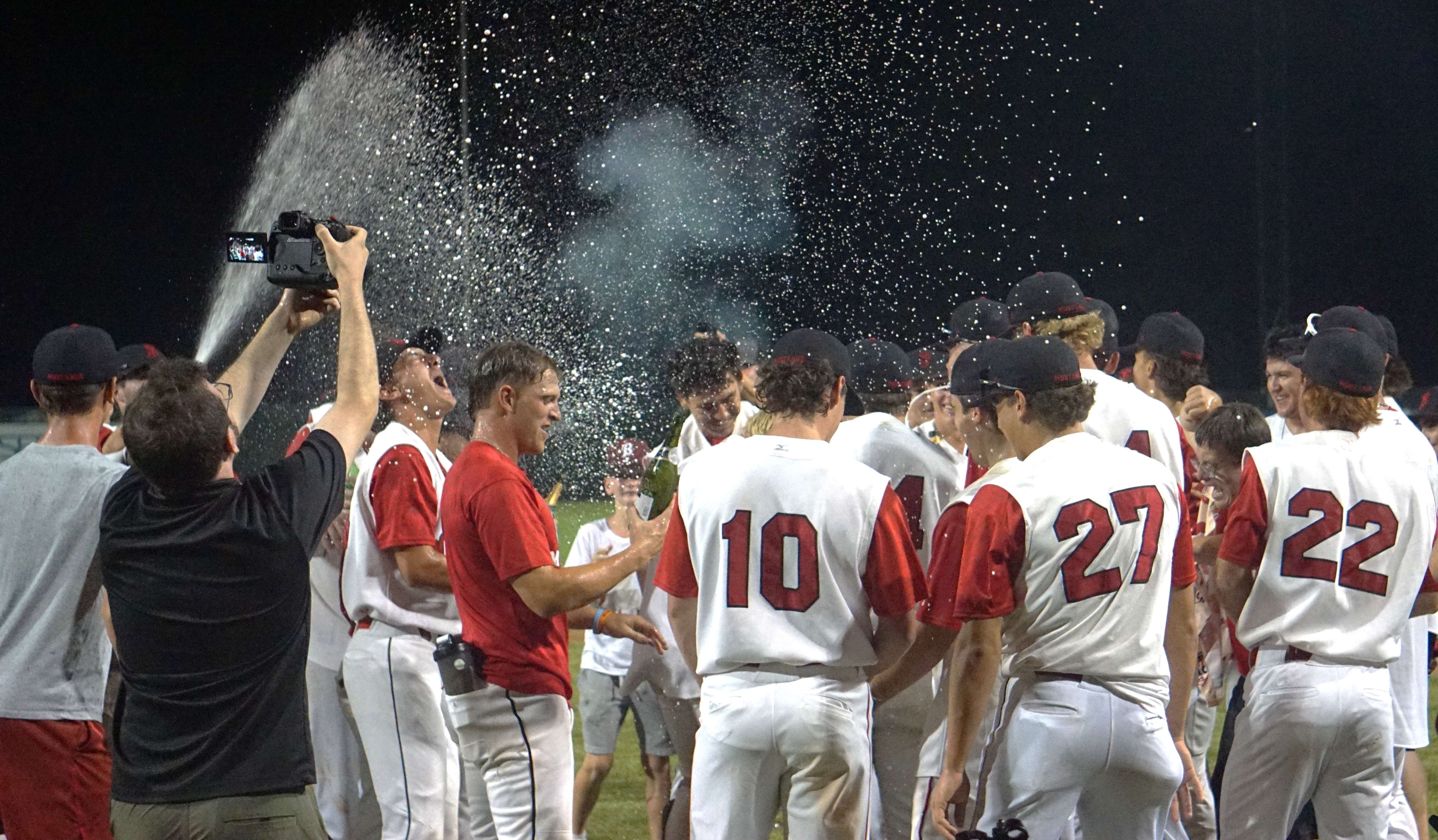 Mustangs players celebrate the 10th MINK League championship in St. Joseph Mustangs history