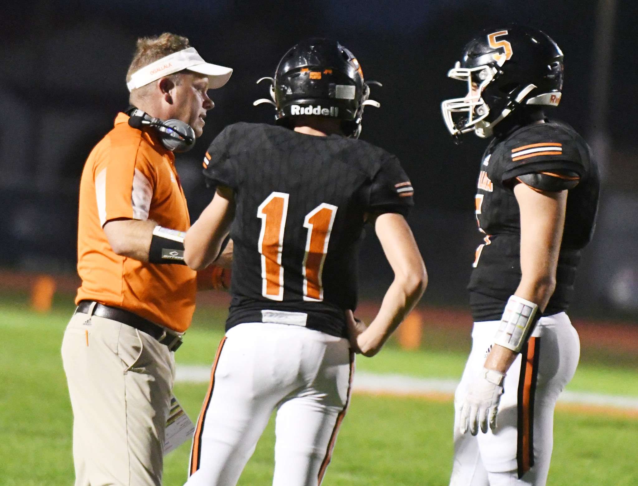 Bauer giving instruction as coach for Ogallala football (photo credit Harry Lipsea, Keith County News)