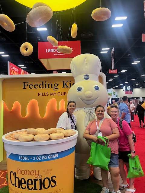 Feeding Kids Fills My Cup – Kristy Alvord, Kayla Hoilien, and Brittany Turner, all members of the USD 428 Food and Nutrition Department, recently attended the School Nutrition Association’s Annual National Conference in San Antonio. The conference provided an opportunity to connect with vendors, learn innovative ideas, and sample new products that meet new USDA guidelines.
