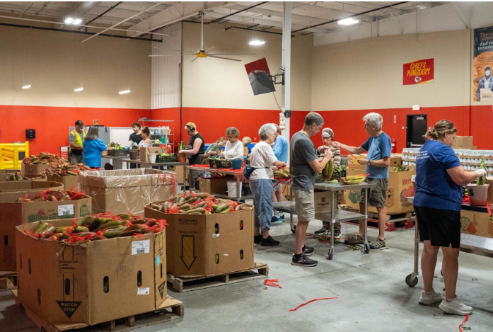 At the Harvesters food bank distribution center in Lawrence, Kansas, volunteers pack produce destined for a local food pantry.&nbsp;Photo by Zane Irwin/Kansas News Service