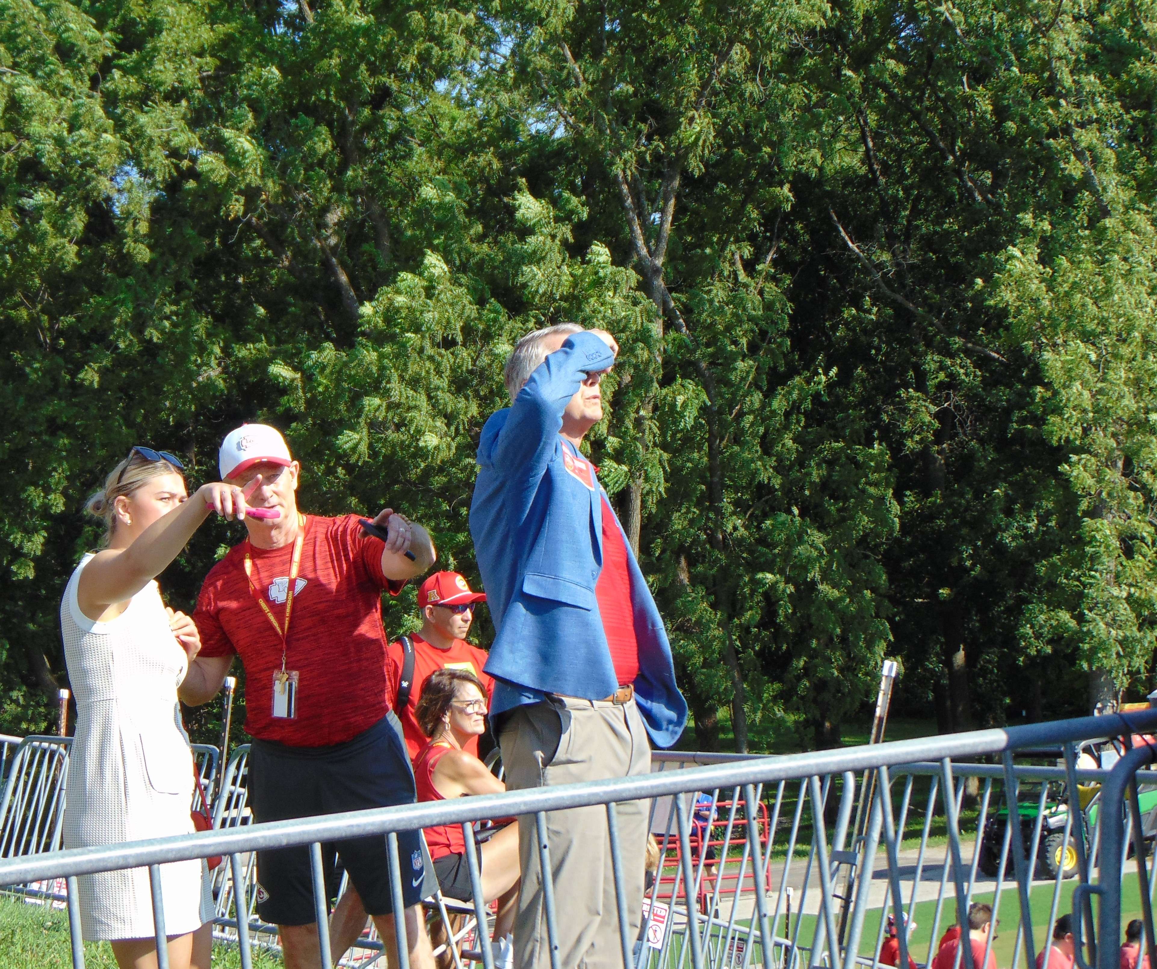 Sen. Roger Marshall shades his eyes as he watches Chiefs Training Camp in St. Joseph. The Voice of the Chiefs, Mitch Holthus, was his guide./Photo by Brent Martin
