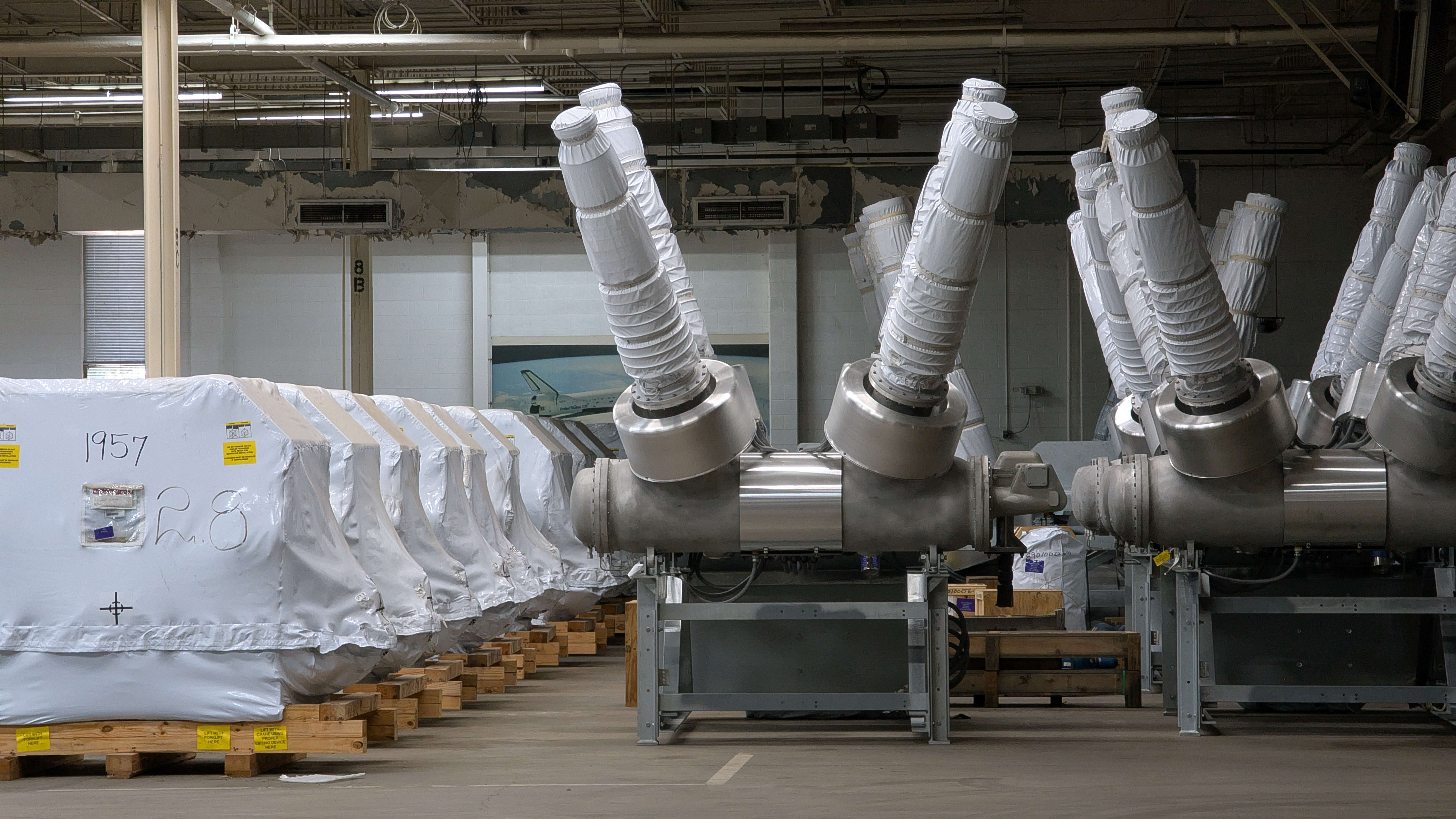 Takkion personnel place a wind turbine transformer component in line with other massive transformers stored in the Fuller Industries Inc. warehouse west of Great Bend recently. The Casper, Wy.-based company, which provides logistics and services for the renewable energy industry, leases space at Fuller for parts used in projects across the country.