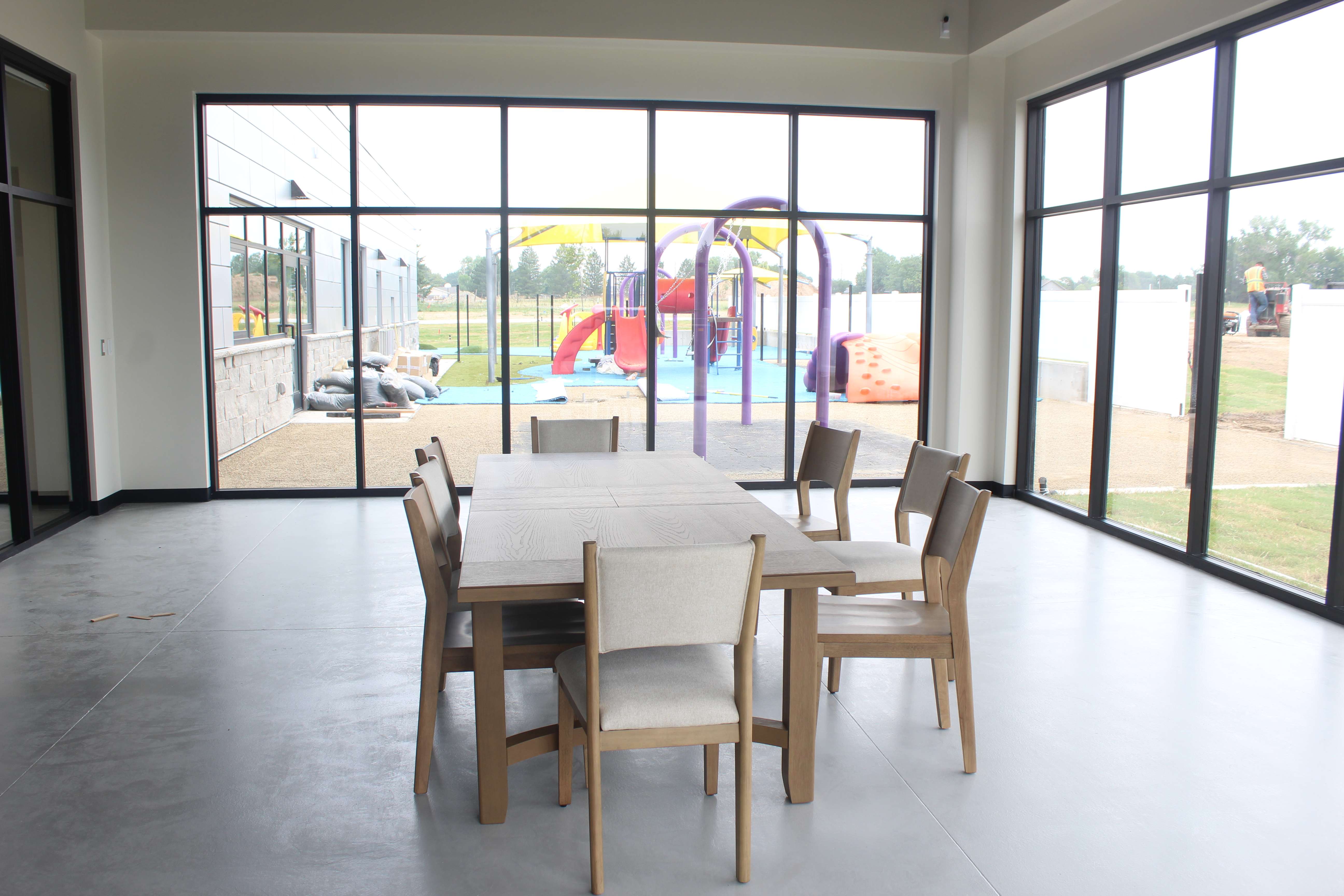 The sun room in the new Bob and Pat Schmidt Community Center looks out onto the child care's playground. The community center was designed to allow intergenerational interactions between seniors and children.&nbsp;Photo by Cristina Janney/Hays Post