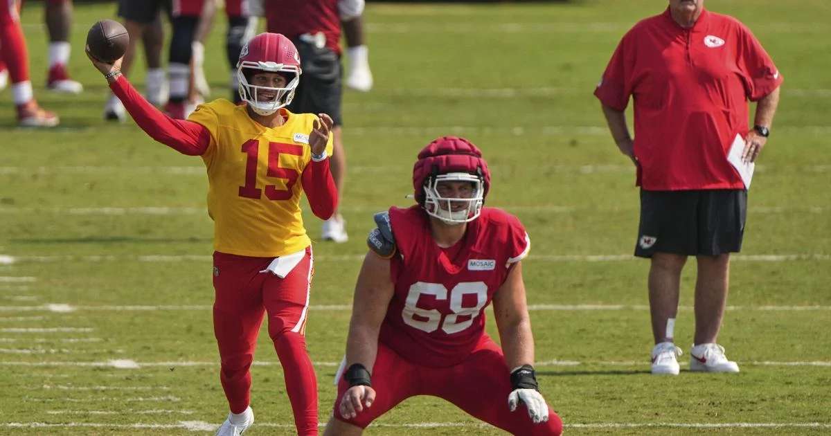 Kansas City Chiefs head coach Andy Reid watches Kansas City Chiefs quarterback Patrick Mahomes (15) and offensive lineman Joey Lombard (68) as they participate in a drill at NFL football training camp Saturday, Aug. 2, 2025, in St. Joseph, Mo. (AP Photo/Charlie Riedel)