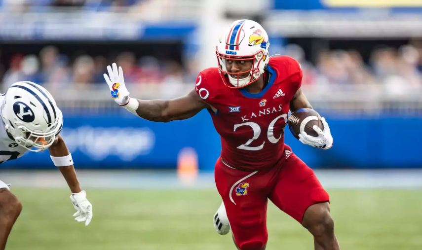 Kansas running back Daniel Hishaw Jr. attempts a stiff arm while rushing against BYU on Saturday, Nov. 16, 2024 in Provo, Utah (KU Athletics photo)