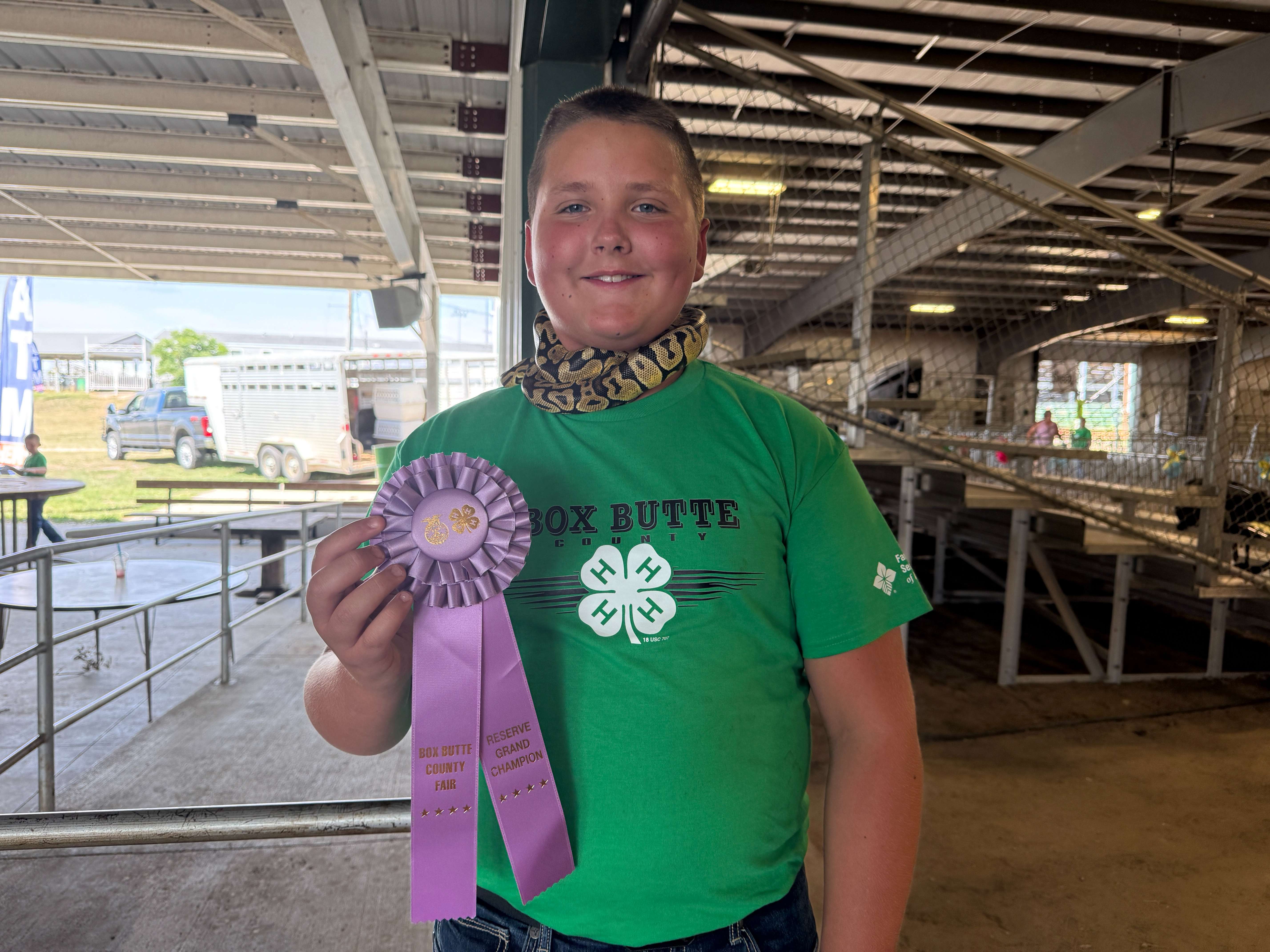 Ryker Tolstedt celebrates Reserve Grand Champion award in Small Pet Show alongside pet snake at 2025 Box Butte County Fair