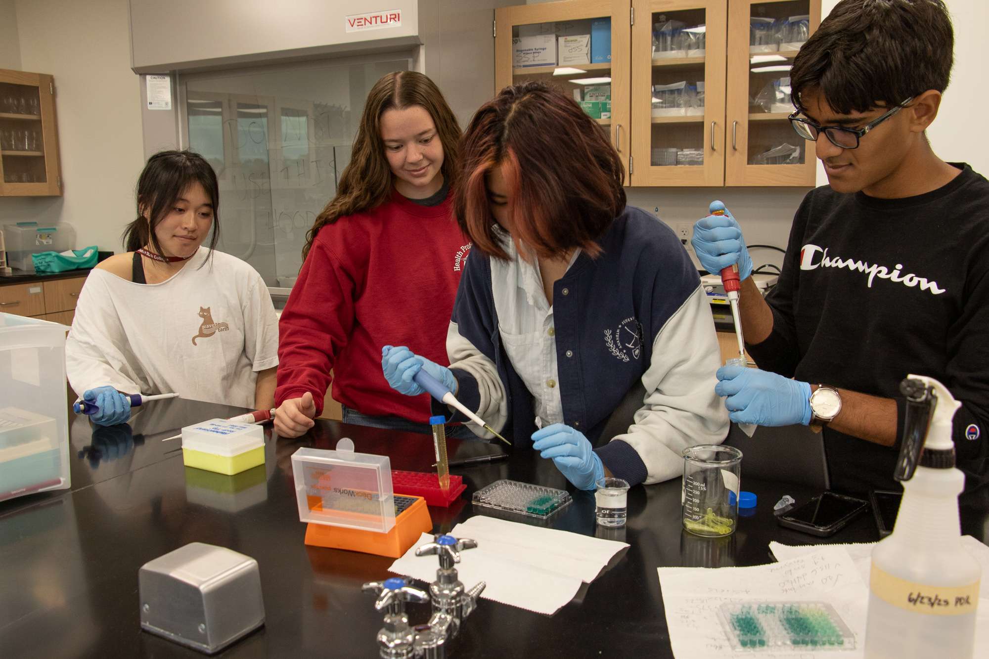 Chadron State College student Piper Ryschon, second from left, serves as a lab assistant with high school students attending the Summer Science Program International (SSPI) in Chadron State College's Center of Innovative Learning on July 10, 2025. From left, Olivia Lu of St. Louis, Mo., Ryschon, Ave Linn of Charlotte, N.C., and Salman Siddiqi of Chicago. (Photo by Tena L. Cook/Chadron State College)