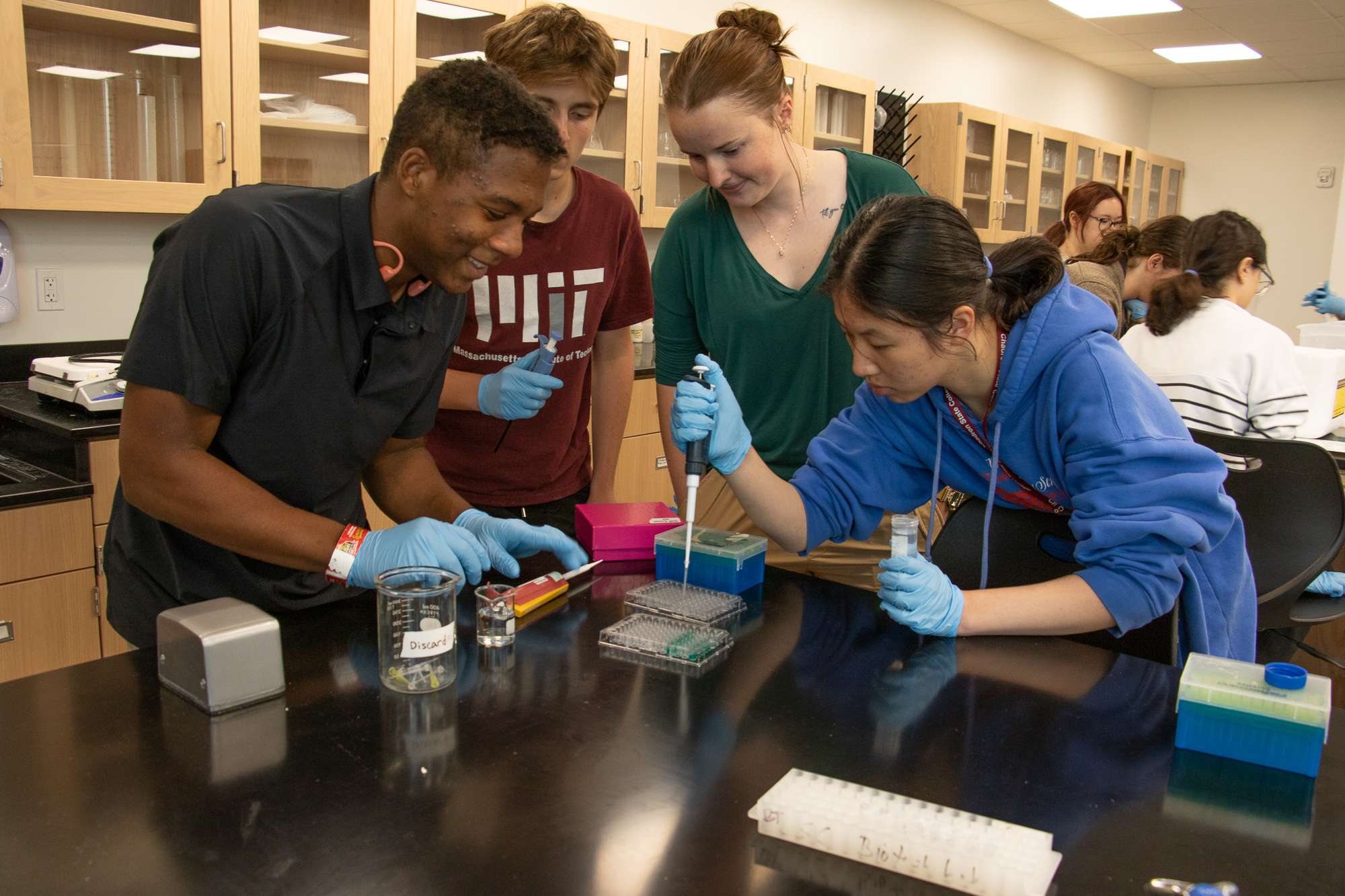Chadron State College student Piper Ryschon, second from left, serves as a lab assistant with high school students attending the Summer Science Program International (SSPI) in Chadron State College's Center of Innovative Learning on July 10, 2025. From left, Olivia Lu of St. Louis, Mo., Ryschon, Ave Linn of Charlotte, N.C., and Salman Siddiqi of Chicago. (Photo by Tena L. Cook/Chadron State College)