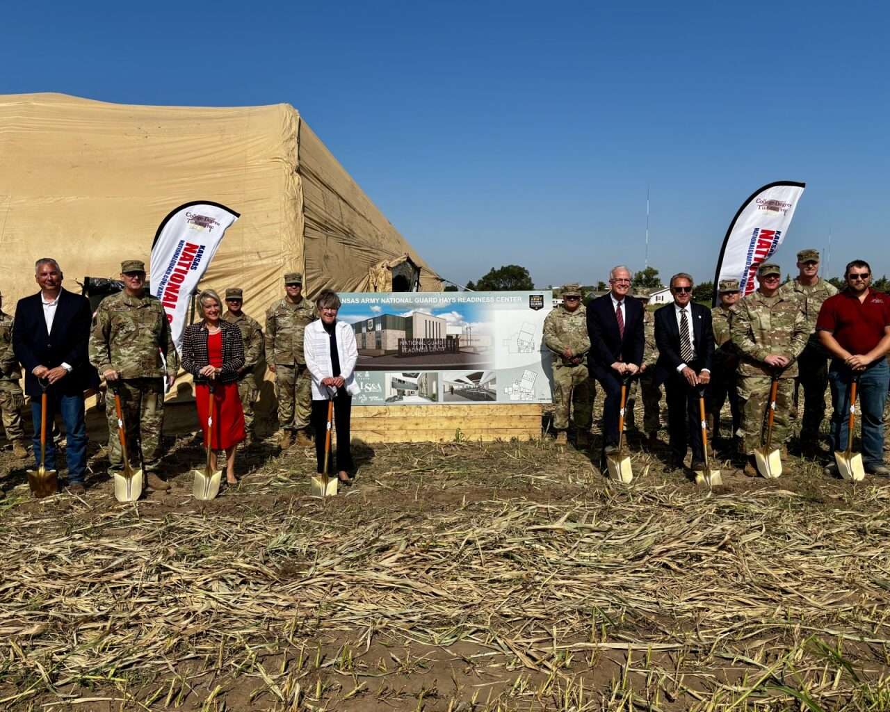 Gov. Laura Kelly with several other officials and Kansas National Guard soldiers holding shovels at the groundbreaking ceremony for a new readiness center in Hays. Photo by Tony Guerrero/Hays Post