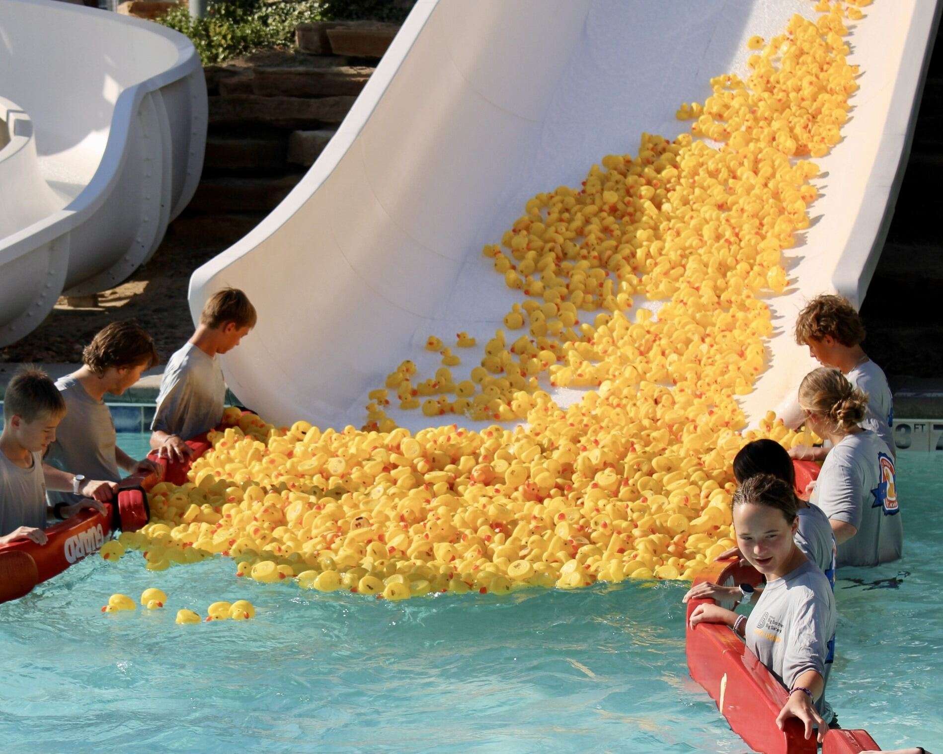 Ducks going down a slide into the lazy river Wednesday at the Hays Aquatic Park during the Big Brothers Big Sisters Duck Derby. Photo by Tony Guerrero/Hays Post