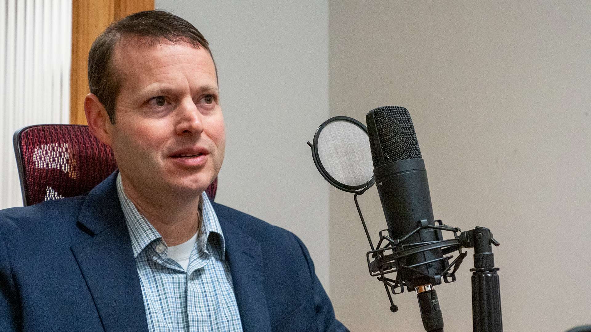 Ryan Vincent, executive director of the Kansas Housing Resources Corporation, appears for a Dec. 19, 2023, recording of the Kansas Reflector podcast.&nbsp; Photo by Sherman Smith/Kansas Reflector
