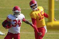 Kansas City Chiefs quarterback Patrick Mahomes (15) chases safety Mike Edwards (34) at NFL football training camp Tuesday, Aug. 5, 2025, in St. Joseph, Mo. (AP Photo/Charlie Riedel)