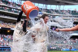 Minnesota Twins' Luke Keaschall is doused with water by Ryan Jeffers (27) after hitting a walk-off two-run home run during the 11th inning of a baseball game against the Kansas City Royals Sunday, Aug. 10, 2025, in Minneapolis. (AP Photo/Abbie Parr)