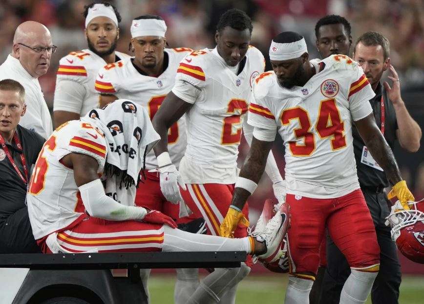 Kansas City Chiefs safety Deon Bush (26) is carted off the field after an injury against the Arizona Cardinals during the first half of an NFL preseason football game, Saturday, Aug. 9, 2025, in Glendale. (AP Photo/Doug Benc)
