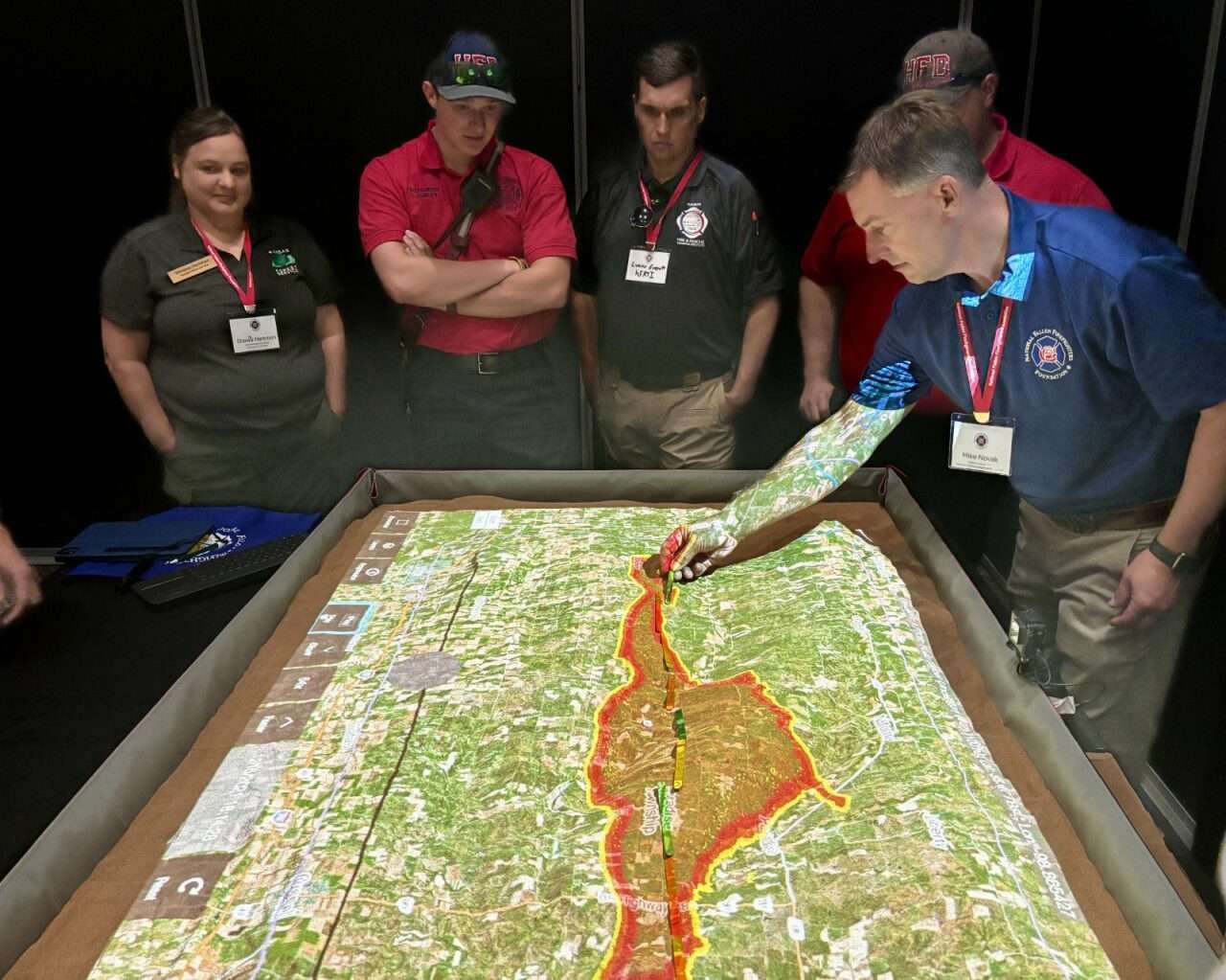 Hays firefighters and other officials measuring the distance of the 2021 Four County Fire at the Wildland Resilience Summit in Hays. Photo by Tony Guerrero/Hays Post